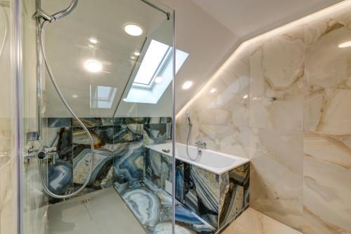 a bathroom with a shower and a sink at Pensiunea Montana Popa in Blaj