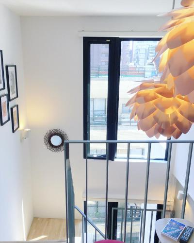 a room with a staircase with a window at Ken's Place四谷 in Tokyo