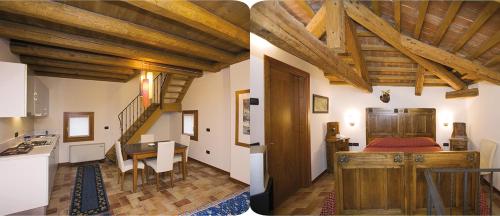 cocina y sala de estar con techos de madera. en Villa San Biagio, en Mason Vicento