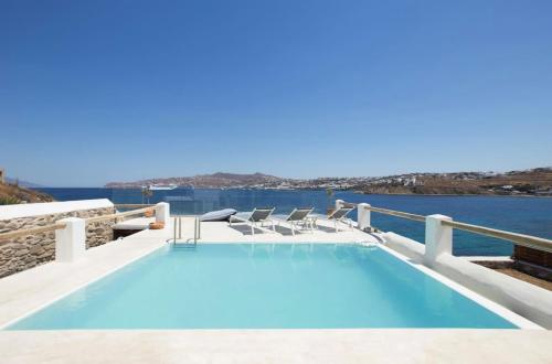 a swimming pool with a view of the water at Villa Maestro Mykonos in Agios Ioannis Mykonos