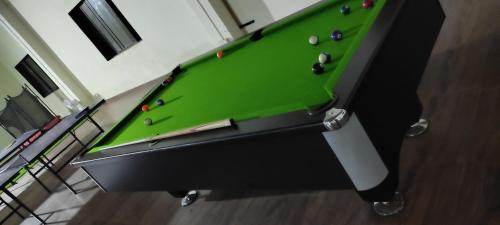 a green pool table with balls on top of it at Mango Valley Resort Ganpatipule in Ratnagiri