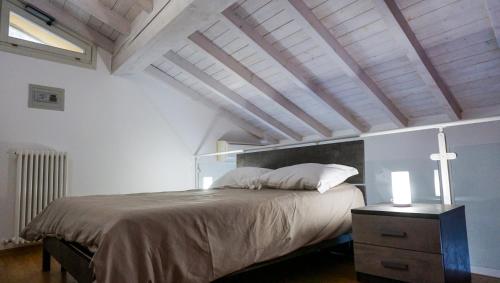 a bedroom with a large bed and a wooden ceiling at Residenze Umberto I in Mantova