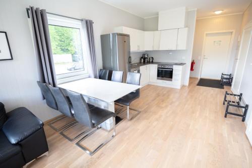 a kitchen and dining room with a table and chairs at Kristiansand Feriesenter in Kristiansand