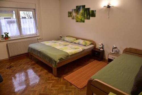 a small bedroom with a bed and a window at Primula Apartment in Blejska Dobrava