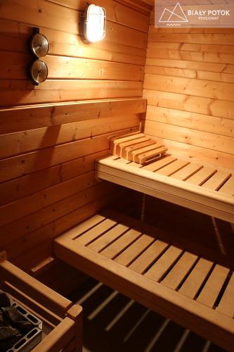 a small wooden sauna with a bench in it at Biały Potok in Zieleniec