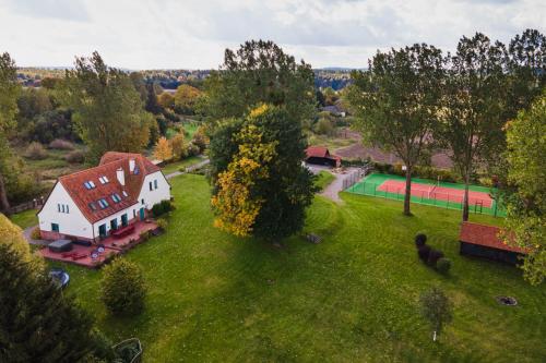 an aerial view of a large white house on a green field at Stara Szkoła Browina in Browina