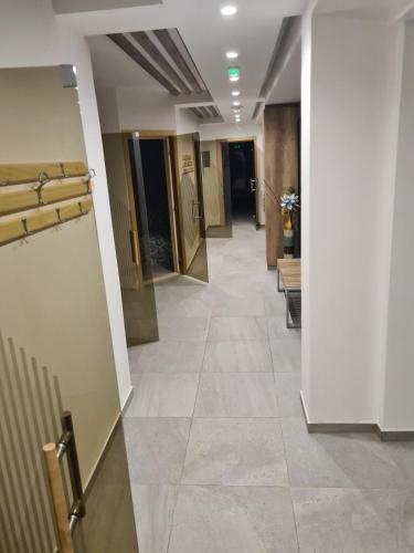 a hallway in a building with a tile floor at PRESIDENT KOP A-1 in Kopaonik