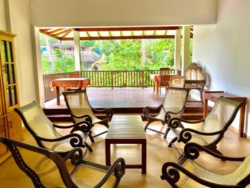 a group of chairs and a table on a porch at Surf Range in Matara
