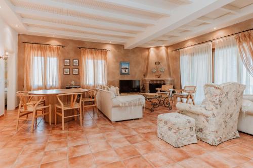a living room with a table and chairs at Unique Thasos Beach Villa in Prinos