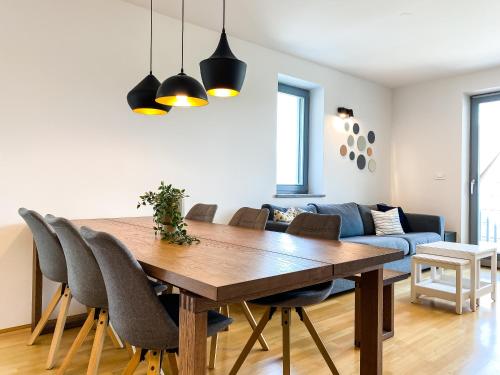 a dining room with a wooden table and chairs at Lakeview Villa Bled in Bled