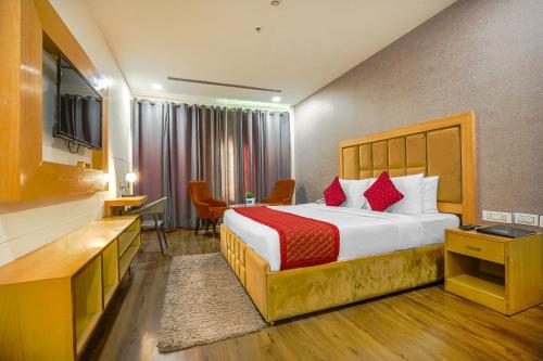 Habitación de hotel con cama y TV en The Stories Hotel, en Ludhiana