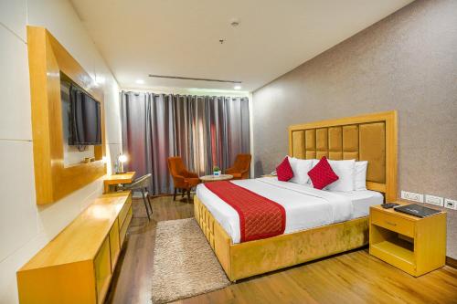 a hotel room with a bed and a desk at The Stories Hotel in Ludhiana