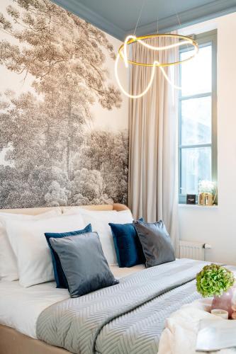 a bedroom with a large bed with a chandelier at Warsaw Story - LoftAffair Collection in Warsaw