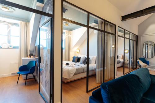 a living room with a couch and a bedroom at Warsaw Story - LoftAffair Collection in Warsaw