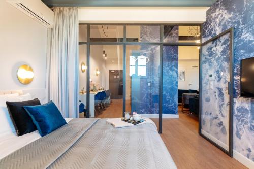 a bedroom with a large bed with blue pillows at Warsaw Story - LoftAffair Collection in Warsaw