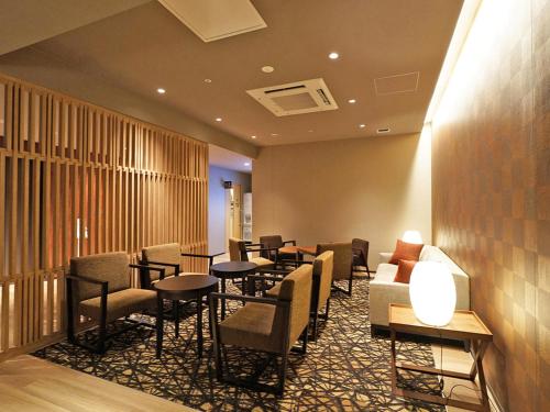 a waiting room with chairs and tables in a hotel at CHISUN PREMIUM Kyoto Kujo in Kyoto
