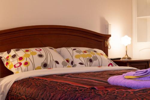 a bed with two pillows on top of it at My Nafpaktos Resort in Nafpaktos