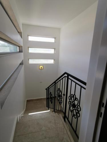 a stairway with a black railing and a window at Villa Tzukim Mitzpe Ramon in Mitzpe Ramon