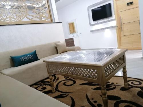 a living room with a couch and a table at Appartement lux dakhla in Dakhla
