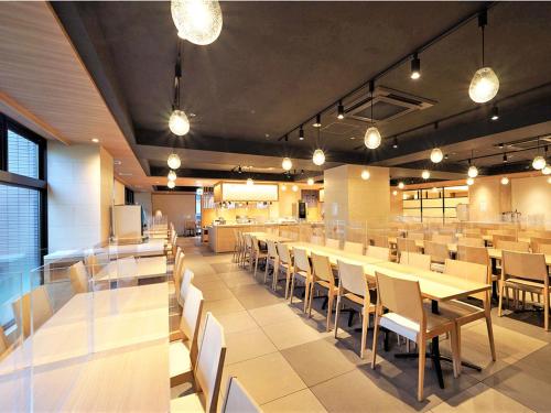 a large dining room with tables and chairs at CHISUN PREMIUM Kyoto Kujo in Kyoto
