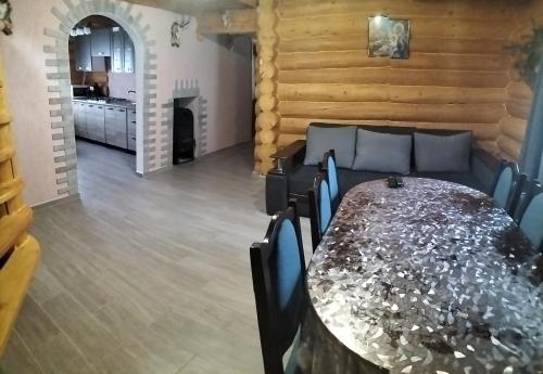 a dining room with a long table and chairs at "Бджілка" і " Садиба для відпочинку" in Lyuta