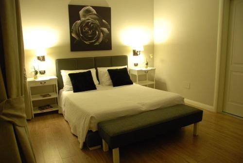 a bedroom with a large bed with two night stands at Maxim in Palermo