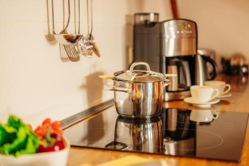 a kitchen counter with a coffee pot on a stove at Bergpanorama in Sankt Andreasberg