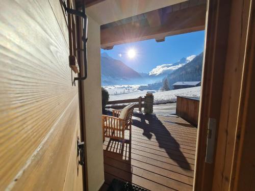 a door to a balcony with a view of a mountain at klein&fein in Neustift im Stubaital