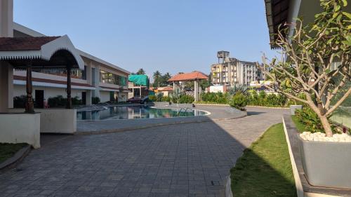 a cobblestone street in a city with a swimming pool at Mayur Belgaum Presidency Hotel & Spa in Belgaum