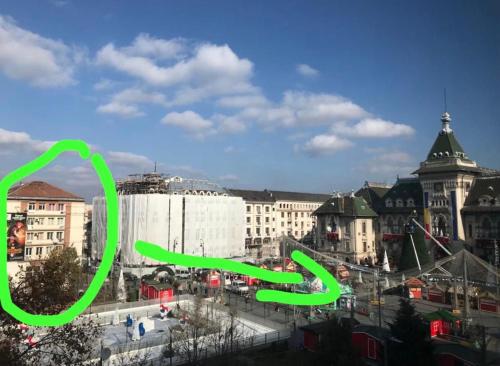 a green sign in front of a city with buildings at Sweet cozy Ultracentral in Craiova