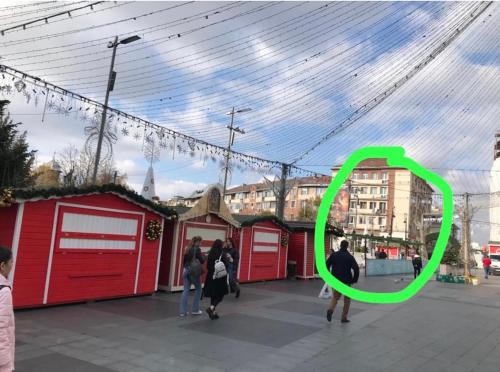 a green circle in front of a group of buildings at Sweet cozy Ultracentral in Craiova