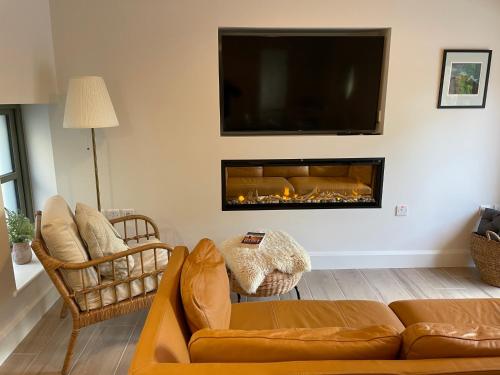 a living room with a couch and a fireplace at The Coach House, Clonakilty in Clonakilty
