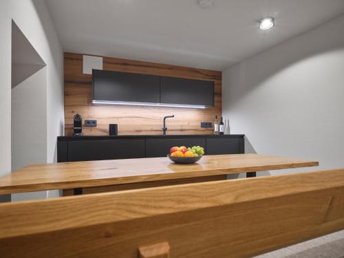 a kitchen with a table with a bowl of fruit on it at HILL - 73 by AA Holiday Homes in Tauplitz