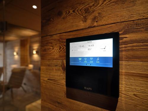 a television on a wooden wall in a room at HILL - 73 by AA Holiday Homes in Tauplitz