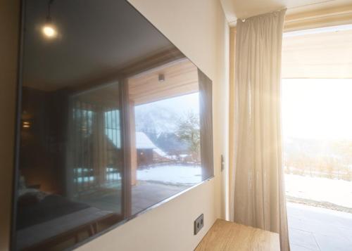 a mirror in a room with a window at HILL - 73 by AA Holiday Homes in Tauplitz