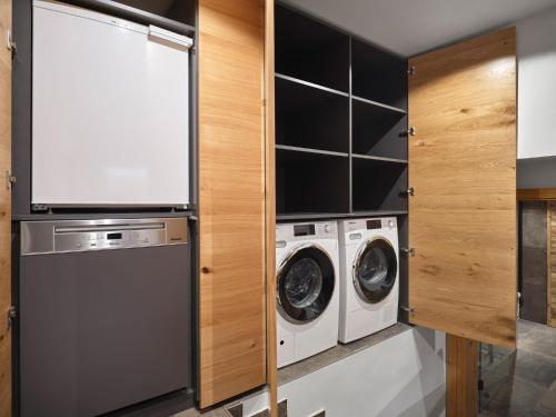 a laundry room with a washer and dryer at HILL - 73 by AA Holiday Homes in Tauplitz