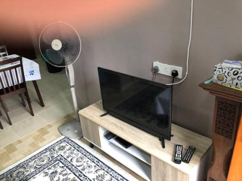a living room with a flat screen tv on a stand at Whole house - 2 bedrooms for family with kids and Free Wifi in Changlun