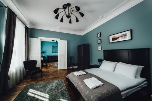 ein Schlafzimmer mit einem Bett und einer blauen Wand in der Unterkunft Sherlock Apartments in Riga
