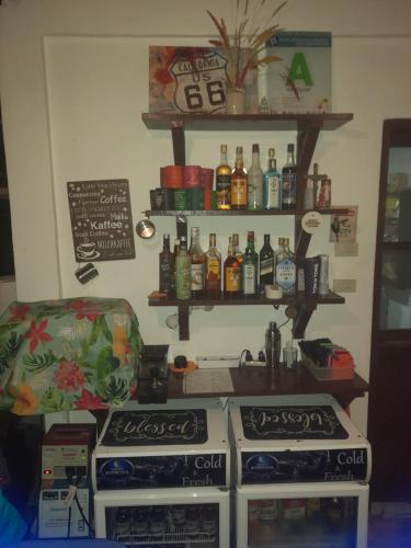 a kitchen with two stoves and a shelf with bottles at DaRosa Del Mar in Santa Monica