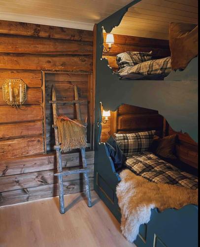 a bedroom with a bed in a log cabin at Traditional timber farm with Sauna & Wi-Fi in Baukål