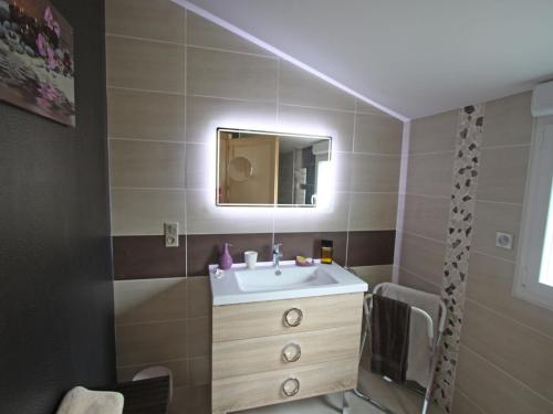 a bathroom with a sink and a mirror at Gîte Chamagne, 3 pièces, 4 personnes - FR-1-589-11 