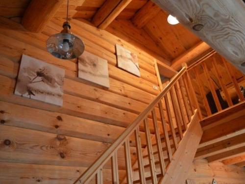 a staircase in a wooden house with pictures on the ceiling at Gîte Anould, 4 pièces, 6 personnes - FR-1-589-49 in Anould