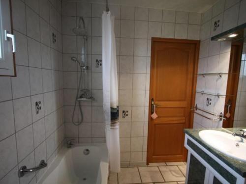 uma casa de banho com um chuveiro, uma banheira e um lavatório. em Gîte Fontenoy-le-Château, 3 pièces, 4 personnes - FR-1-589-69 em Fontenoy-le-Château