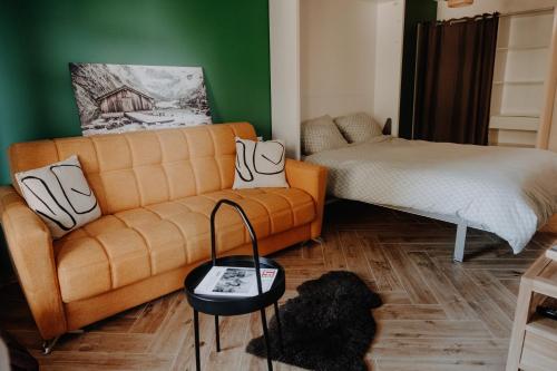 a living room with a couch and a bed at Cosy and modern apartment closed to the ski lift in Crans-Montana