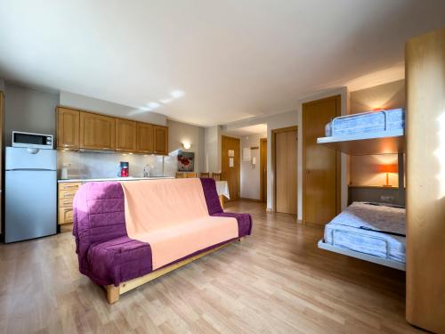a living room with a purple couch and a bunk bed at Nuria Pedrous in Pas de la Casa