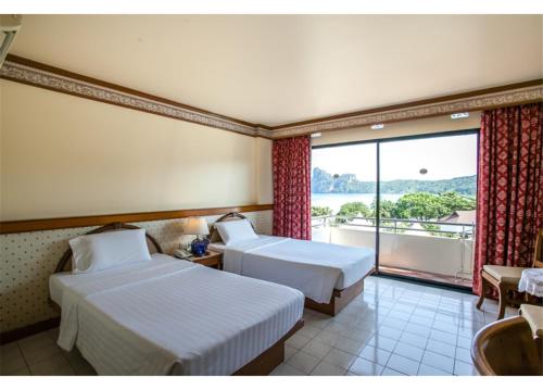 a hotel room with two beds and a large window at Phi Phi Hotel in Phi Phi Islands