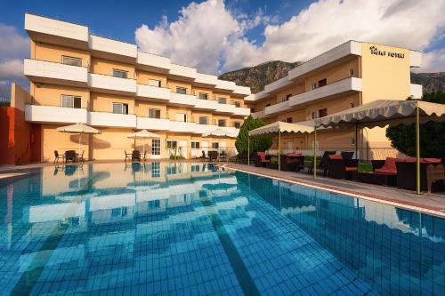 a large swimming pool in front of a hotel at Hotel Fotini in Kalamata