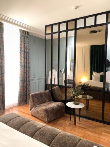 a living room with a couch and a table at Hôtel Singulier Bordeaux in Bordeaux