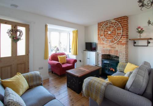 a living room with two couches and a fireplace at Stylish Town Centre House with Garden and Parking Opposite in Bury Saint Edmunds