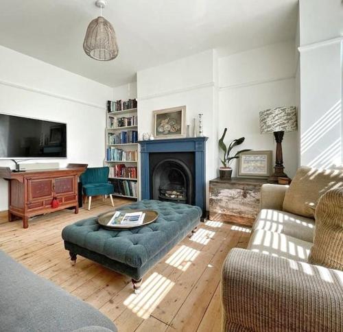 a living room with a couch and a fireplace at Home away from Home - Broadstairs beautiful family seaside house with garden and parking in Kent